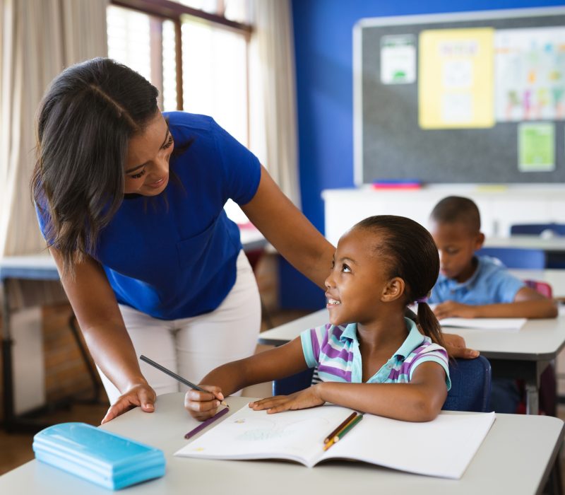 African american female teacher teaching african american girl i African american female teacher teaching african american girl i